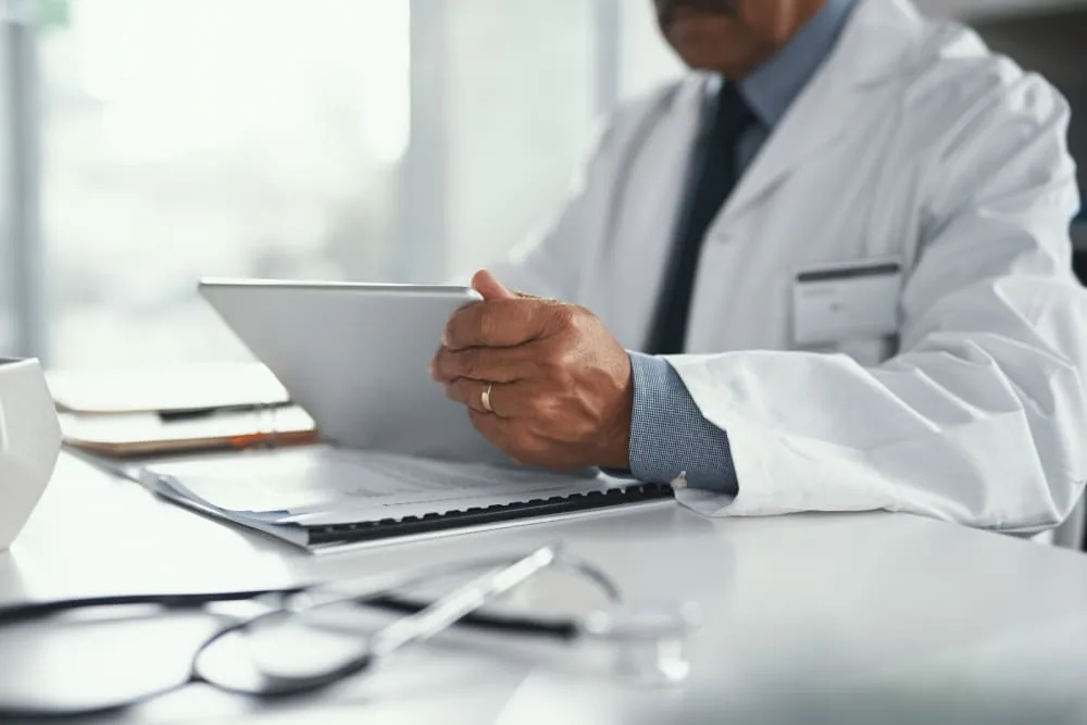Dermatologist reviewing patient insurance and medical paperwork